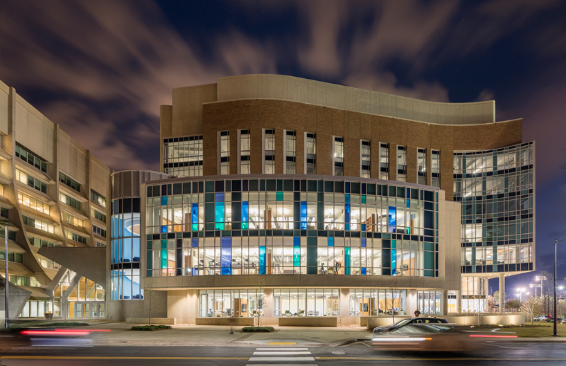 Vanderbilt campus Engineering and Science Building (ESB) at night, with an illuminated glass facade.